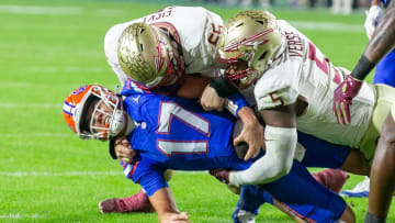 Florida Gators quarterback Max Brown (17) gets stopped by Florida State Seminoles defensive lineman Jared Verse (5) and Florida State Seminoles defensive lineman Braden Fiske (55) during first half action as Florida takes on Florida State at Steve Spurrier Field at Ben Hill Griffin Stadium in Gainesville, FL on Saturday, November 25, 2023. [Alan Youngblood/Gainesville Sun]