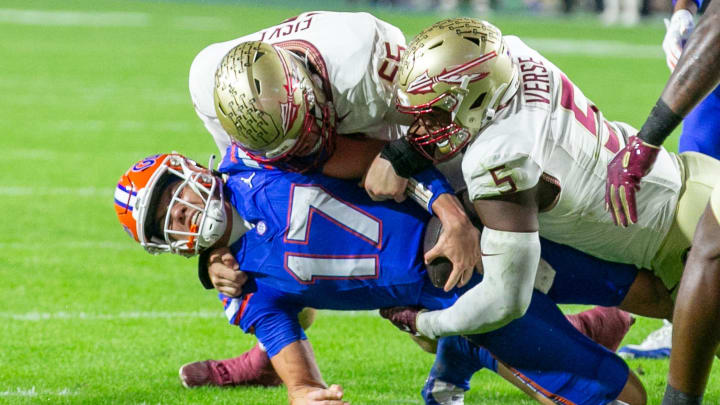 Florida Gators quarterback Max Brown (17) gets stopped by Florida State Seminoles defensive lineman Jared Verse (5) and Florida State Seminoles defensive lineman Braden Fiske (55) during first half action as Florida takes on Florida State at Steve Spurrier Field at Ben Hill Griffin Stadium in Gainesville, FL on Saturday, November 25, 2023. [Alan Youngblood/Gainesville Sun]