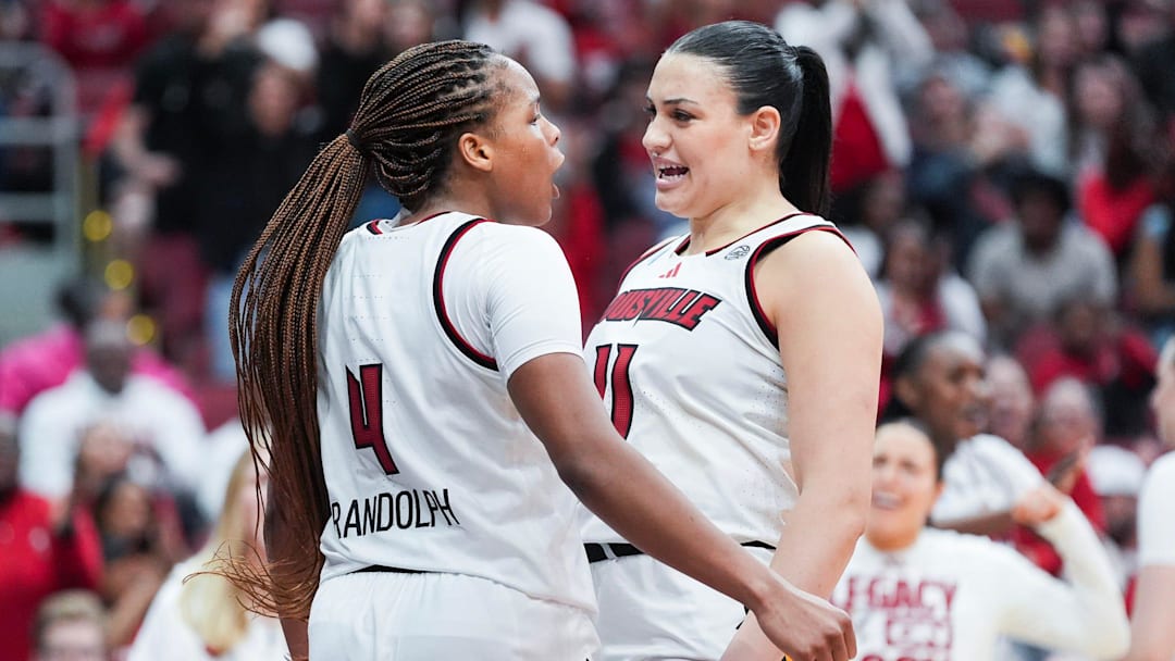 Louisville Cardinals forward MacKenly Randolph (4) celebrates after scoring plus drawing with teammate Louisville Cardinals forward Elif Istanbulluoglu (11) during the game against Vermont at the 2026 NCAA Women's March Madness basketball tournament at the KFC Yum Center In Louisville, Kentucky. March 21, 2026.
