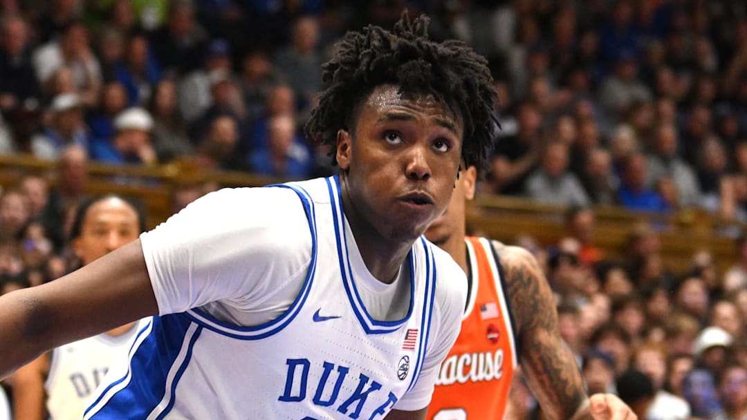Feb 16, 2026; Durham, North Carolina, USA;  Duke Blue Devils center Patrick Ngongba II (21) brings the ball around Syracuse Orange forward William Kyle (42) during the during the second half at Cameron Indoor Stadium. Mandatory Credit: Zachary Taft-Imagn Images