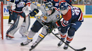 Erie Otters forward Carey Terrance, center, and Saginaw Spirit defenseman Pacey Schlueting battle for the puck during the first period on Oct. 23, 2021, at Erie Insurance Arena in Erie. It was the first game back on home ice after 594 days away due to the pandemic.

P7otters102321