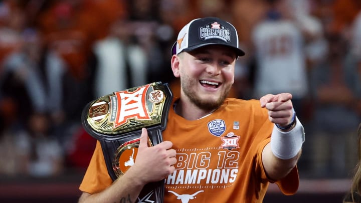 Dec 2, 2023; Arlington, TX, USA; Texas Longhorns quarterback Quinn Ewers (3) reacts with the WWE Big 12 championship belt after the win against the Oklahoma State Cowboys at AT&T Stadium. Mandatory Credit: Kevin Jairaj-USA TODAY Sports