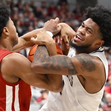 Washington's Keion Brooks Jr. (1) gets fouled by Washington State's Jaylen Wells (0) in their game in Pullman in March. 
