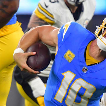 Nov 9, 2025; Inglewood, California, USA; Pittsburgh Steelers linebacker Nick Herbig (51) sacks Los Angeles Chargers quarterback Justin Herbert (10) during the second quarter of the game at SoFi Stadium. Mandatory Credit: Gary A. Vasquez-Imagn Images