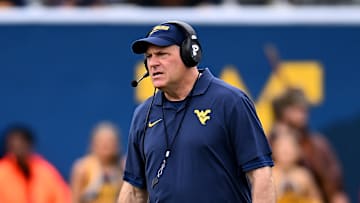 West Virginia football's Rich Rodriguez patrols the field during the team's 2025 Gold-Blue Spring Showcase.