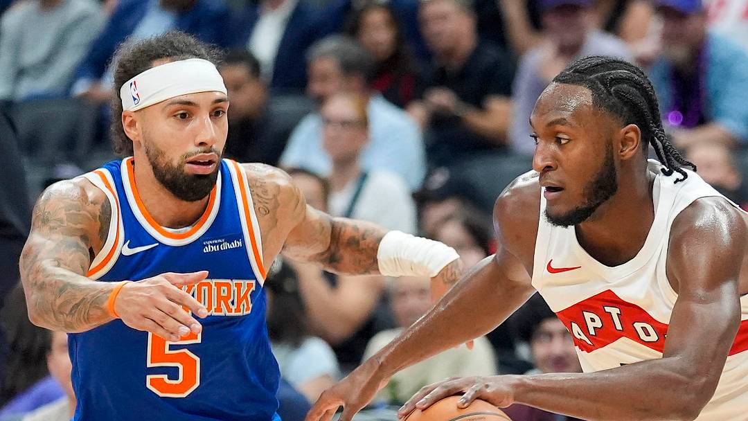 Toronto Raptors guard Immanuel Quickley dribbles the ball up court against New York Knicks guard Jose Alvarado. Toronto Raptors guard Immanuel Quickley dribbles the ball up court against New York Knicks guard Jose Alvarado.