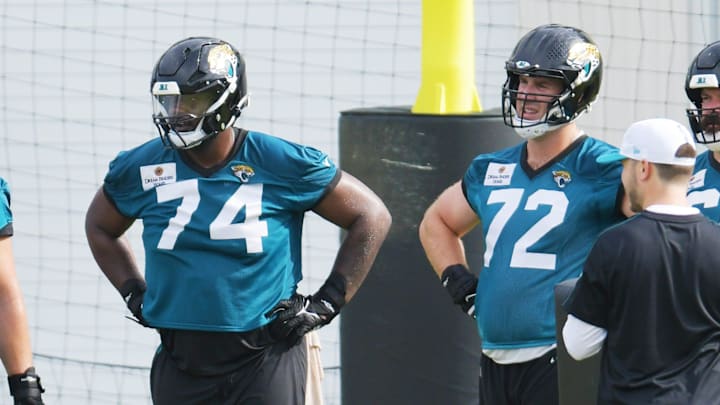 Jacksonville Jaguars guard Ezra Cleveland (76) with offensive tackle Cam Robinson (74) and offensive tackle Walker Little (72) during a break between drills during the second day of an NFL football training camp practice session Thursday, July 25, 2024 at EverBank StadiumÕs Miller Electric Center in Jacksonville, Fla.