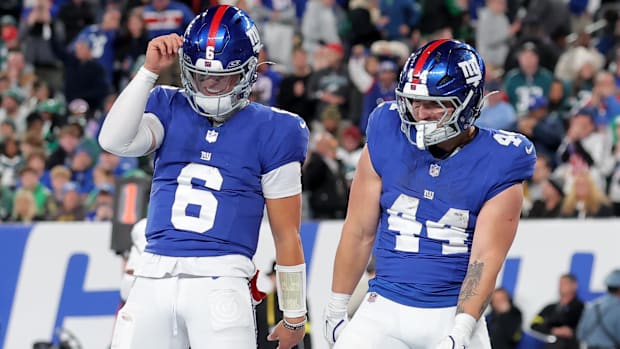 New York Giants quarterback Jaxson Dart (6) and running back Cam Skattebo (44) celebrate Skattebo's touchdown.