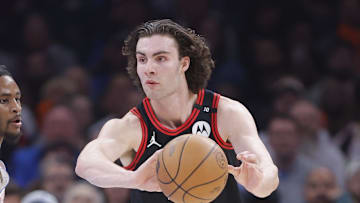 Mar 31, 2025; Oklahoma City, Oklahoma, USA; Chicago Bulls guard Josh Giddey (3) passes around Oklahoma City Thunder guard Cason Wallace (22) during the second quarter at Paycom Center. Mandatory Credit: Alonzo Adams-Imagn Images