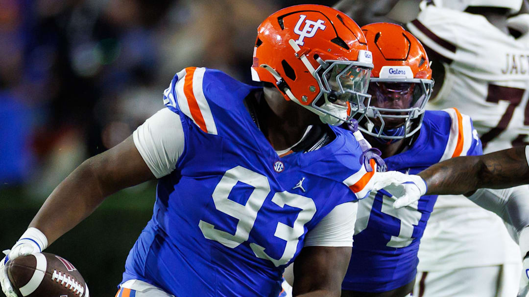 Florida Gators defensive tackle Michai Boireau (93) celebrates with safety Bryce Thornton (18) after an interception during the second half at Ben Hill Griffin Stadium. 