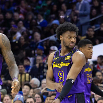 Jan 28, 2025; Philadelphia, Pennsylvania, USA; Los Angeles Lakers forward LeBron James (23) and guard Bronny James (9) look on during the third quarter against the Philadelphia 76ers at Wells Fargo Center. Mandatory Credit: Bill Streicher-Imagn Images