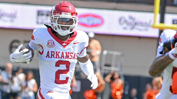 Razorbacks wide receiver Andrew Armstrong runs behind a teammate's block after catching a pass against Oklahoma State