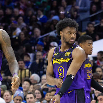 Jan 28, 2025; Philadelphia, Pennsylvania, USA; Los Angeles Lakers forward LeBron James (23) and guard Bronny James (9) look on during the third quarter against the Philadelphia 76ers at Wells Fargo Center. Mandatory Credit: Bill Streicher-Imagn Images