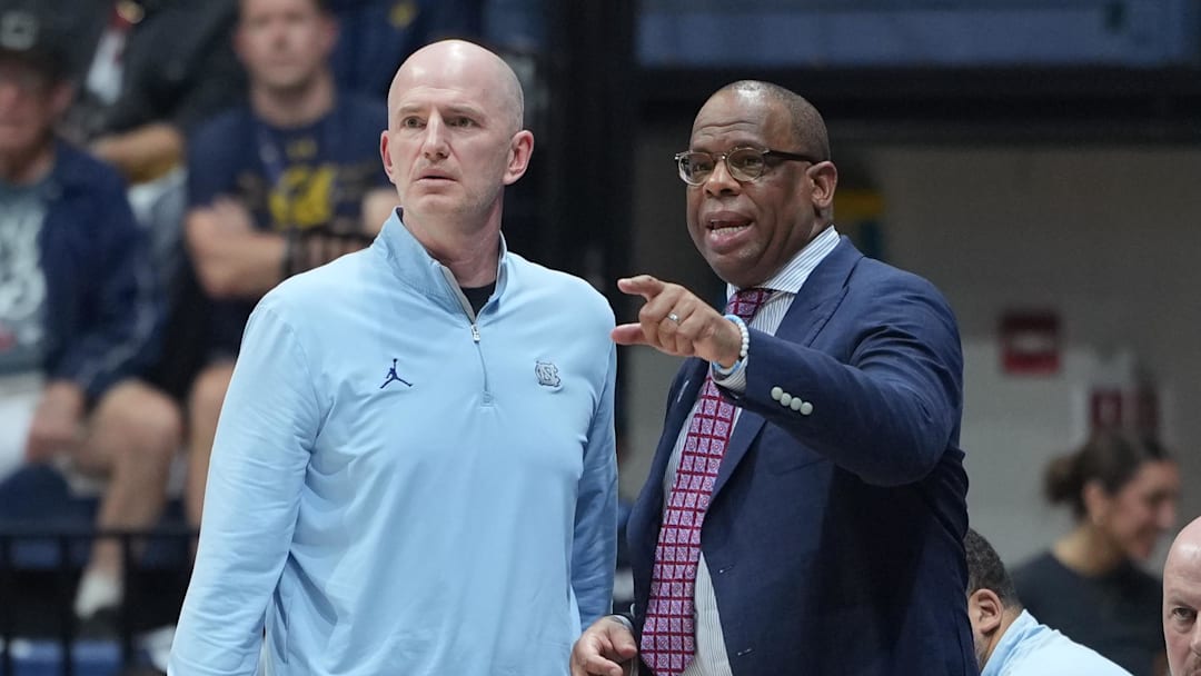 Jan 17, 2026; Berkeley, California, USA; North Carolina Tar Heels assistant coach Brad Frederick (left) and head coach Hubert Davis (right) talk during the first half against the California Golden Bears at Haas Pavilion. Mandatory Credit: Darren Yamashita-Imagn Images
