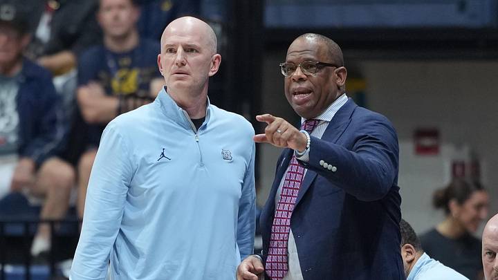 Jan 17, 2026; Berkeley, California, USA; North Carolina Tar Heels assistant coach Brad Frederick (left) and head coach Hubert Davis (right) talk during the first half against the California Golden Bears at Haas Pavilion. Mandatory Credit: Darren Yamashita-Imagn Images