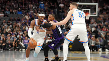 Nov 7, 2025; Sacramento, California, USA; Oklahoma City Thunder guard Shai Gilgeous-Alexander (2) dribbles past Sacramento Kings guard Russell Westbrook (18) in the third quarter at the Golden 1 Center. Mandatory Credit: Cary Edmondson-Imagn Images