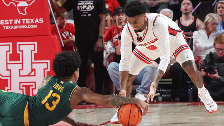 Houston's Mylik Wilson (right) goes after a loose ball against Baylor.