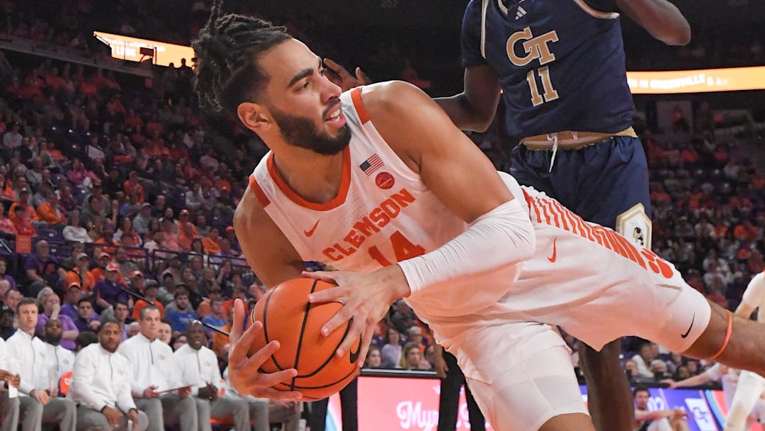 Clemson center Christian Reeves (14) saves a ball near Georgia Tech forward Baye Ndongo (11) during the first half at Littlejohn Coliseum in Clemson, S.C. Tuesday, February 4, 2025.