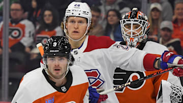 Oct 27, 2024; Philadelphia, Pennsylvania, USA; Montreal Canadiens center Christian Dvorak (28) batted with Philadelphia Flyers defenseman Jamie Drysdale (9) form position in front of goaltender Aleksei Kosolov (35) during the first period at Wells Fargo Center. Mandatory Credit: Eric Hartline-Imagn Images
