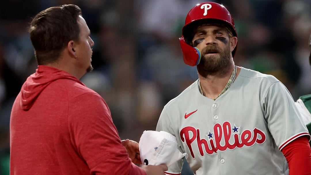 Philadelphia Phillies first baseman Bryce Harper (3) is looked at by a trainer after being hit by a pitch against the Athletics during the sixth inning at Sutter Health Park.