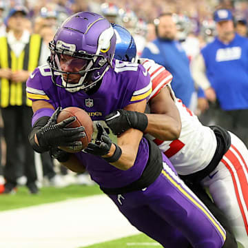 Jan 15, 2023; Minneapolis, Minnesota, USA; Minnesota Vikings wide receiver Justin Jefferson (18) dives for the end zone as New York Giants cornerback Adoree' Jackson (22) defends during the first quarter of a wild card game at U.S. Bank Stadium. The call on the field was a touchdown but was changed after review. Mandatory Credit: Matt Krohn-Imagn Images