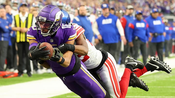 Jan 15, 2023; Minneapolis, Minnesota, USA; Minnesota Vikings wide receiver Justin Jefferson (18) dives for the end zone as New York Giants cornerback Adoree' Jackson (22) defends during the first quarter of a wild card game at U.S. Bank Stadium. The call on the field was a touchdown but was changed after review. Mandatory Credit: Matt Krohn-Imagn Images