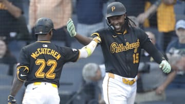 Pittsburgh Pirates center fielder Oneil Cruz (15) celebrates his solo home run with designated hitter Andrew McCutchen (22) against the Miami Marlins during the first inning at PNC Park. 