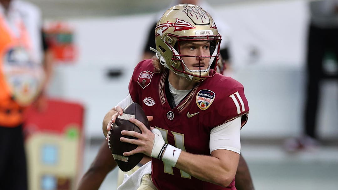 Dec 30, 2023; Miami Gardens, FL, USA; Florida State Seminoles quarterback Brock Glenn (11) drops back to pass against the Georgia Bulldogs during the first half in the 2023 Orange Bowl at Hard Rock Stadium. Mandatory Credit: Nathan Ray Seebeck-Imagn Images