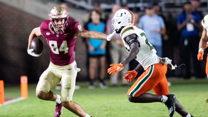 Florida State Seminoles tight end Kyle Morlock (84) pushes back a defender. The Florida State Seminoles defeated the Miami Hurricanes 27-20 on Saturday, Nov. 11, 2023.