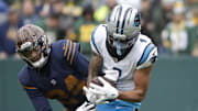 Nov 2, 2025; Green Bay, Wisconsin, USA; Carolina Panthers wide receiver Tetairoa McMillan (4) pulls down a first down reception against Green Bay Packers cornerback Carrington Valentine (24) during their football game at Lambeau Field. Mandatory Credit: Dan Powers-USA TODAY Network via Imagn Images