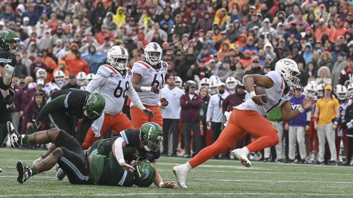 Dec 27, 2023; Annapolis, MD, USA;  Virginia Tech Hokies quarterback Kyron Drones (1) runs for a first half touchdown against the Tulane Green Wave at Navy-Marine Corps Memorial Stadium. Mandatory Credit: Tommy Gilligan-USA TODAY Sports