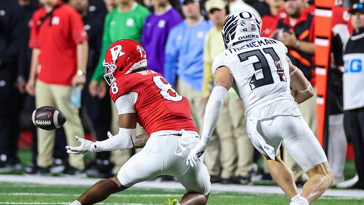 Oct 18, 2025; Piscataway, New Jersey, USA;  Rutgers Scarlet Knights wide receiver Kj Duff (8) makes a catch during the second half in front of Oregon Ducks defensive back Dillon Thieneman (31) at SHI Stadium. Mandatory Credit: Vincent Carchietta-Imagn Images