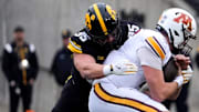 Iowa Hawkeyes defensive lineman Aaron Graves (95) sacks Minnesota Golden Gophers quarterback Drake Lindsey (5) Oct. 25, 2025 at Kinnick Stadium in Iowa City, Iowa.