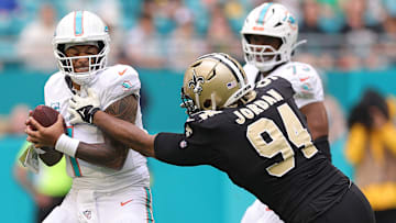 New Orleans Saints DE Cam Jordan (94) goes to sack Miami Dolphins QB Tua Tagovailoa (1) on Nov. 30, 2025.