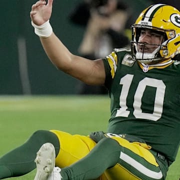 Green Bay Packers quarterback Jordan Love looks for help after getting sacked by the Eagles.