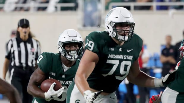 Michigan State Spartans offensive tackle Jarrett Horst (79) blocks for running back Kenneth Walker III (9)