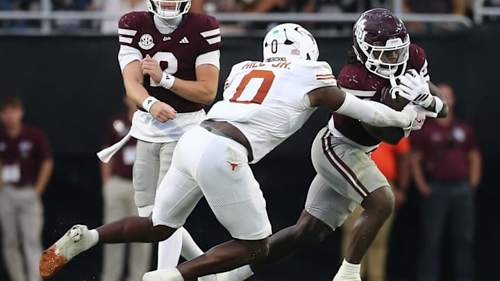 Oct 25, 2025; Starkville, Mississippi, USA; Mississippi State Bulldogs running back Davon Booth (6) runs the ball  as Texas Longhorns linebacker Anthony Hill Jr. (0) makes the tackle during the third quarter at Davis Wade Stadium at Scott Field. Mandatory Credit: Petre Thomas-Imagn Images