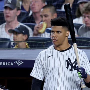 Jun 7, 2024; Bronx, New York, USA; New York Yankees right fielder Juan Soto (22) holds a bat on the top step of the dugout during the seventh inning against the Los Angeles Dodgers at Yankee Stadium. Mandatory Credit: Brad Penner-USA TODAY Sports