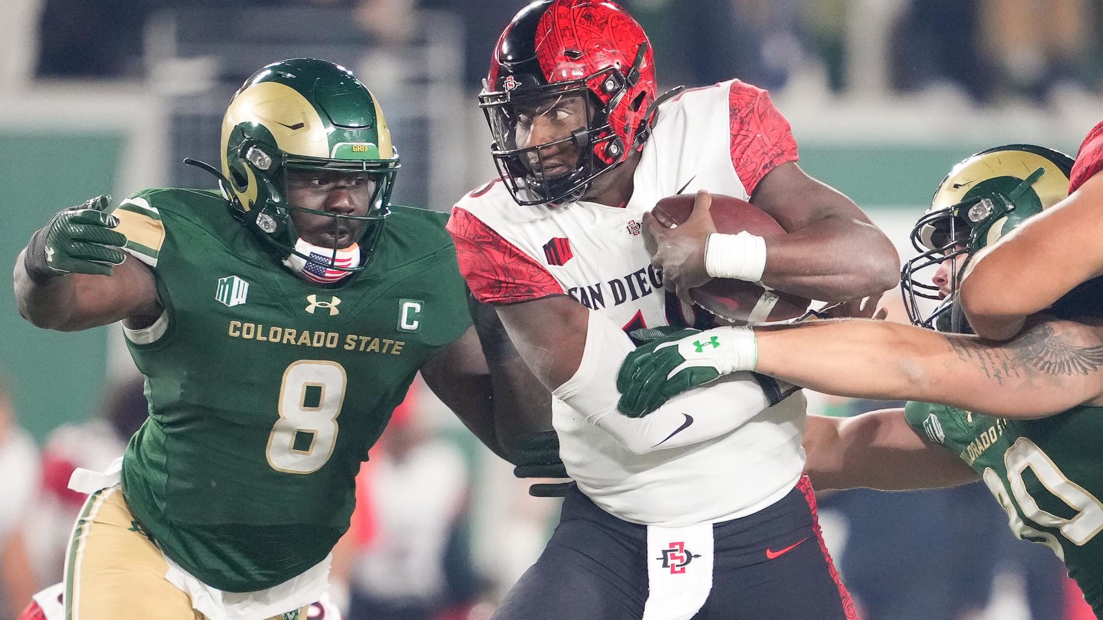 Mohamed Kamara of Colorado State closes in on San Diego State QB Jalen Mayden from the side last season.