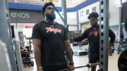 Former University of Maryland football players Delmar Glaze, left, and Gottlieb Ayedze work out at