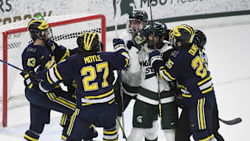 Wolverine and Spartan rivals scuffle on the ice Friday, Feb. 10, 2023, at Munn Ice Arena during the first period at Munn Ice Arena.