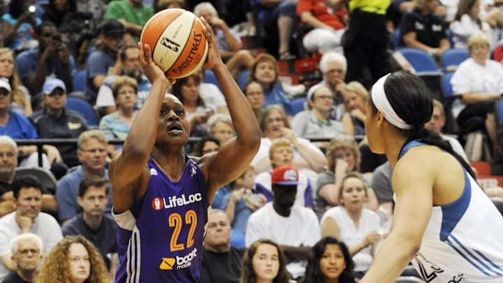 Jul 24, 2013; Minneapolis, MN, USA;  Phoenix Mercury forward Charde Houston (22) shoots over Minnesota Score forward Maya Moore (23) in the third quarter at Target Center.  The Lynx defeated the Mercury 81-69.  Mandatory Credit: Marilyn Indahl-Imagn Images