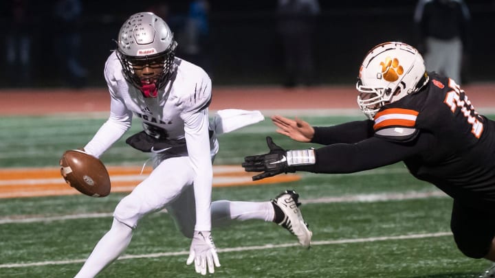 Harrisburg quarterback Shawn Lee Jr. escapes a sack attempt from Central York's Danny Pham during a PIAA District 3 Class 6A semifinal game at Central York High School on Friday, Nov. 18, 2022, in Emigsville.

Hes Dr 111822 Cyfb