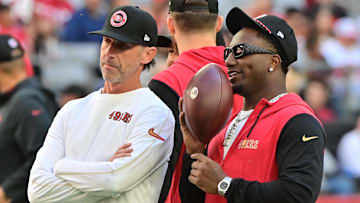 Jan 5, 2025; Glendale, Arizona, USA; San Francisco 49ers head coach Kyle Shanahan (left) and wide receiver Deebo Samuel Sr. (right) look on prior to the game against the Arizona Cardinals at State Farm Stadium. Mandatory Credit: Matt Kartozian-Imagn Images