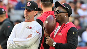 Jan 5, 2025; Glendale, Arizona, USA; San Francisco 49ers head coach Kyle Shanahan (left) and wide receiver Deebo Samuel Sr. (right) look on prior to the game against the Arizona Cardinals at State Farm Stadium. Mandatory Credit: Matt Kartozian-Imagn Images