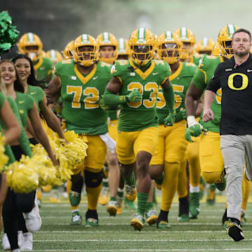 Nov 9, 2024; Eugene, Oregon, USA; Oregon Ducks head coach Dan Lanning leads his team before the start of a game against the Maryland Terrapins at Autzen Stadium. Mandatory Credit: Troy Wayrynen-Imagn Images