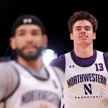 Mar 21, 2024; Brooklyn, NY, USA; Northwestern Wildcats guard Brooks Barnhizer (13) and Northwestern Wildcats guard Boo Buie (0) run drills during team practice at Barclays Center. Mandatory Credit: Brad Penner-Imagn Images