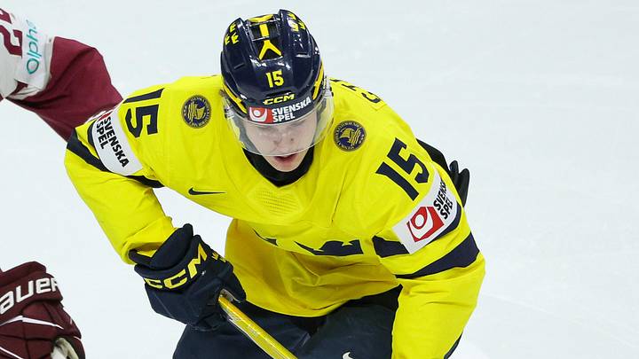 Jan 2, 2026; St. Paul, Minnesota, UNITED STATES; Sweden forward Ivar Stenberg (15) skates with the puck as Latvia forward Daniels Serkins (24) defends during the second period in the quarterfinals of the 2026 IIHF World Junior Championship at Grand Casino Arena. Mandatory Credit: Matt Krohn-Imagn Images