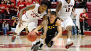 Nov. 09, 2012; Tuscaloosa, AL, USA;  South Dakota Jackrabbits guard Brayden Carlson (12) is fouled by Alabama Crimson Tide guard Levi Randolph (20) during the first half at Coleman Coliseum.  Mandatory Credit: Kelly Lambert-Imagn Images