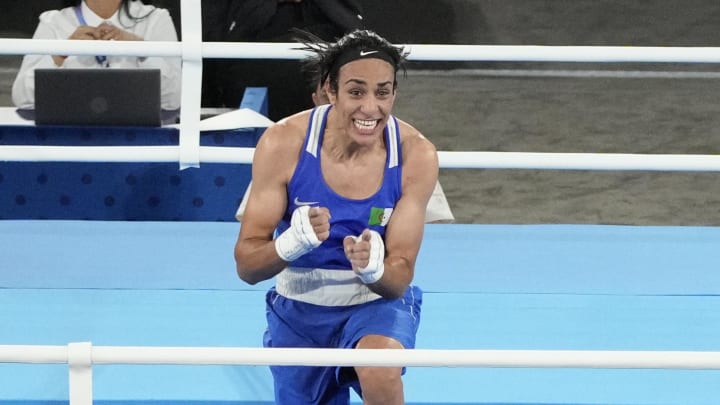 Aug 6, 2024; Paris, France; Imane Khelif (ALG) celebrates defeating Janjaem Suwannapheng (THA) in a women's 66kg semifinal bout during the Paris 2024 Olympic Summer Games at Stade Roland Garros.